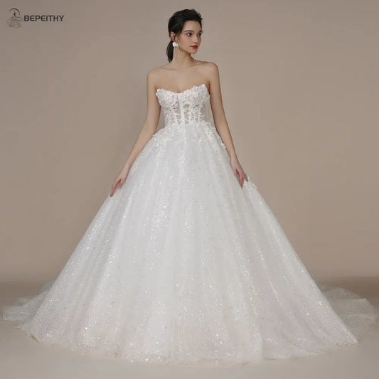 BEPEITHY Princess Strapless Ivory Glitter Wedding Dresses 2023 For WomSPECIFICATIONSBrand Name: BEPEITHYStyle: ClassicNeckline: StraplessSleeve Length(cm): sleevelessTrain: Court TrainOrigin: Mainland ChinaCN: AnhuiDresses Length: FlooJohnny TirakJohnny TirakWomen Court Train Bride 3D Flower Romantic Shinny Bridal Gown